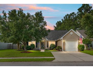 Charming one-story home with manicured lawn, mature trees, and attached two-car garage in quiet neighborhood at 213 Avonshire Dr, Summerville, SC 29483
