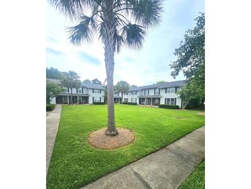 A condo complex with a manicured lawn and palm trees at 2494 Etiwan Ave # 9-D, Charleston, SC 29414
