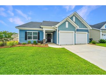 Charming home showcasing a two-car garage, manicured lawn, and beautiful blue siding at 302 Fiddleback Dr, Summerville, SC 29486