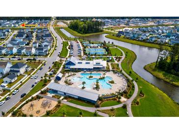 An aerial view showcasing the community amenities, including a pool, tennis courts, and lake at 312 Clearpath Dr, Summerville, SC 29486