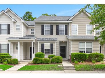 Charming townhouse featuring neutral siding, black shutters, and manicured landscaping for inviting curb appeal at 333 Flyway Rd, Goose Creek, SC 29445