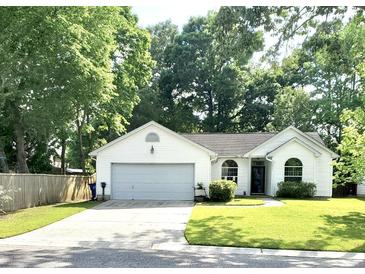 Charming single-story home with a manicured lawn and attached two-car garage at 3415 Pawtucket St, Charleston, SC 29414