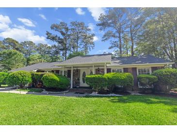Charming single-story home with a well-maintained front yard and covered porch at 411 Dogwood Circle, Summerville, SC 29485