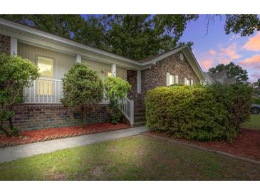 Charming brick home featuring a well-manicured lawn and welcoming front porch at 436 Fox Hunt Rd, Goose Creek, SC 29445