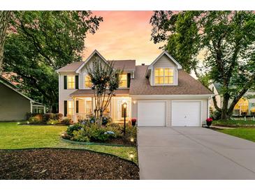 Charming home featuring a landscaped yard, two-car garage, and inviting front porch at 448 Jardinere Walk, Mount Pleasant, SC 29464
