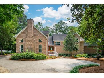 Stunning brick home featuring lush landscaping and a circular driveway at 125 Drayton Dr, Summerville, SC 29483