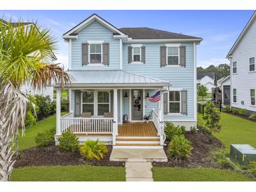 Charming light blue two-story home featuring a cozy front porch and well-manicured lawn at 1832 Agate Bay Dr, Mount Pleasant, SC 29466