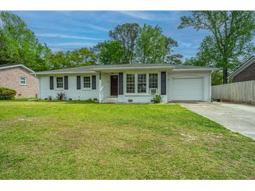Charming ranch-style home with a manicured lawn and attached garage in a desirable neighborhood at 1917 Piper Dr, Charleston, SC 29407