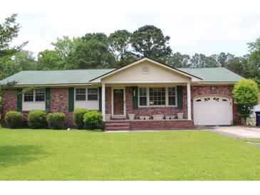 Charming single-story brick home with green roof, lush lawn, and attached garage at 2163 Pinehurst Ave, Charleston, SC 29414