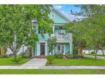 Charming two-story home with a porch, balcony, well-maintained lawn and lush landscaping at 300 Foxglove Ave, Summerville, SC 29483