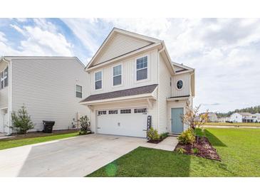 Charming two-story home with an attached garage and well-manicured lawn at 519 Purple Finch Rd, Summerville, SC 29486