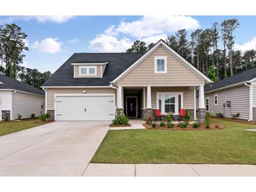 Charming single-Gathering home with a two-car garage, inviting front porch, and manicured lawn at 1384 Locals St, Summerville, SC 29485