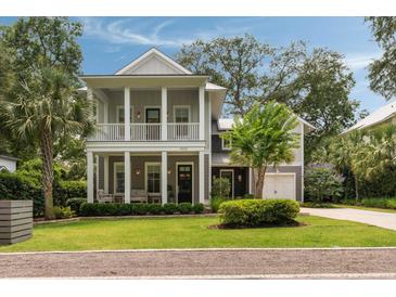Charming two-story home with a double porch, lush landscaping, and a well-manicured lawn at 1405 Mataoka St, Mount Pleasant, SC 29464