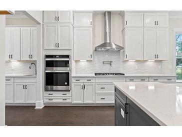 Well-lit modern kitchen featuring white cabinets, stainless steel appliances, and stylish countertops at 1427 Dahlia Rd, Mount Pleasant, SC 29464