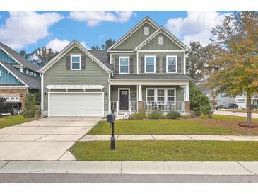 Charming two-story home with a welcoming front porch and well-manicured lawn and an attached two-car garage at 202 Center Hill Ct, Summerville, SC 29485