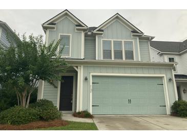 Charming two-story home with light-blue siding, a two-car garage, and a well-manicured front yard at 2208 Primus Rd, Mount Pleasant, SC 29466