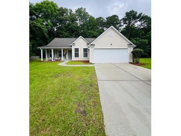 Charming single-story home with a well-manicured lawn and covered front porch at 2844 Curran Pl, Mount Pleasant, SC 29466