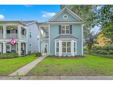 Charming two-story home featuring a quaint front porch and a neatly manicured lawn at 3152 Riverine, Charleston, SC 29414