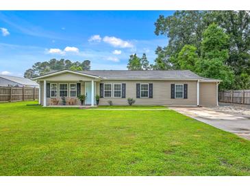 Charming single-story home with a well-manicured lawn, a covered porch, and neutral siding at 337 Price St, Goose Creek, SC 29445