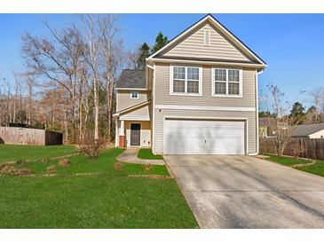 Charming two-story home with a well-maintained lawn and attached two-car garage at 3506 Galaxy Rd, Ladson, SC 29456