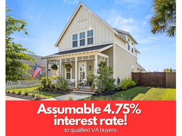 Charming two-story home with a welcoming front porch and beautifully landscaped yard at 383 Oak Park St, Summerville, SC 29486