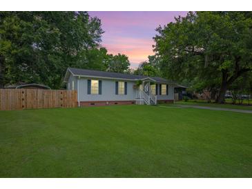 Charming single-story home features a well-maintained lawn, privacy fence, and inviting front porch at 401 Amy Dr, Goose Creek, SC 29445