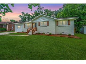 Charming single-story home features a well-manicured lawn and inviting front porch at 4233 Oakridge Dr, North Charleston, SC 29418