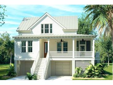 Inviting two-story home boasts a metal roof, covered front porch, and a beautifully landscaped yard with native palm trees at 5005 Saltspray Ln, Johns Island, SC 29455