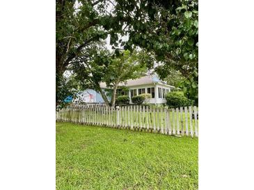 Charming home with a welcoming picket fence and lush greenery provides cozy curb appeal at 608 Dolphin Dr, Summerville, SC 29485