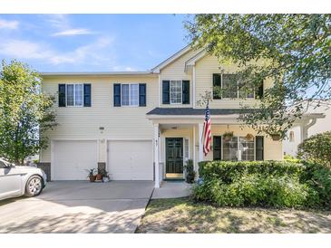 Charming two-story home featuring a two-car garage, well-kept landscaping, and an inviting front porch at 67 Regency Oaks Dr, Summerville, SC 29485
