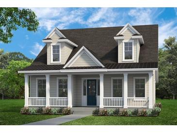 Charming home with a covered porch, white columns, dormer windows, and a well-manicured lawn at 100 E Carolina Ave, Summerville, SC 29483