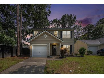 Inviting two-story home with a well-manicured lawn, attached garage, and classic curb appeal at 110 Yorkshire Dr, Summerville, SC 29483