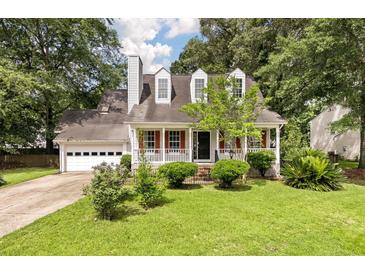 Charming two-story home with red shutters and a landscaped front yard and an attached two car garage at 117 Berringer Dr, Goose Creek, SC 29445