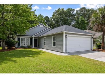 Charming single-story home with a well-manicured lawn, gray siding, and an attached two-car garage at 1420 Wellesley Cir, Mount Pleasant, SC 29466