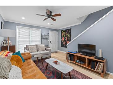 Bright living room with comfortable seating, stylish decor, and modern ceiling fan at 1713 Boone Hall Dr # 1082, Charleston, SC 29407