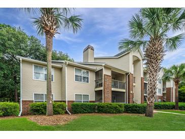 Well-maintained building with brick accents, tidy landscaping, and mature palm trees at 2011 N Highway 17 # 1400A, Mount Pleasant, SC 29466