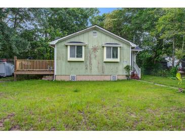 Charming bungalow style home featuring a quaint front porch and well-maintained lawn and landscape at 2702 Decatur St, North Charleston, SC 29405