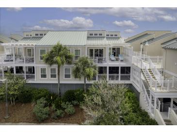 Inviting multi-story condo with private balconies, palm trees, and lush landscaping at 2942 Atrium Villa Dr # 42, Johns Island, SC 29455