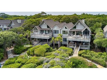 Stunning two-story home with multiple decks, lush landscaping, and private boardwalk at 3560 Shipwatch Rd, Kiawah Island, SC 29455