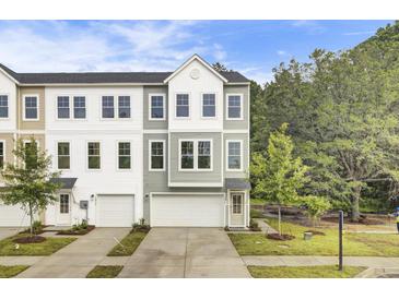 Three-story townhome with a two-car garage and neutral-colored siding at 432 Caledon Ct, Johns Island, SC 29455