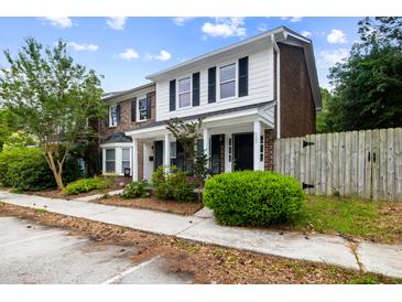 Charming townhome featuring a classic brick and siding facade with well-maintained landscaping at 655 Swinton Ct, Mount Pleasant, SC 29464