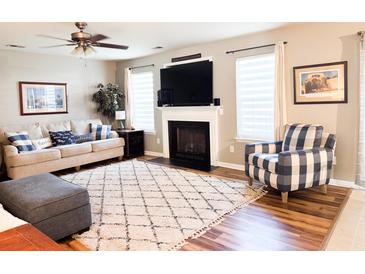 Comfortable living room featuring a fireplace, plush seating, and a ceiling fan at 9229 N Moreto Cir, Summerville, SC 29485