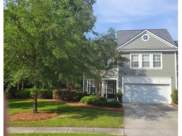 Charming two-story home with a well-manicured front yard and attached two-car garage at 101 Fresh Meadow Ln, Mount Pleasant, SC 29466