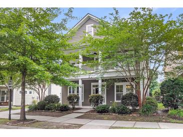 Charming two-story home featuring a spacious front porch and beautifully landscaped front yard with mature trees at 1523 Nautical Chart Dr, Charleston, SC 29414