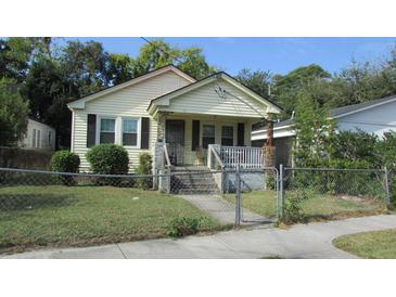Charming one-story home with a cozy front porch, mature trees, and a fenced-in yard at 47 Oswego St, Charleston, SC 29403