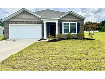 Charming single-story home with brick accents, a two-car garage, and a well-manicured lawn at 505 Shady Maple St, Moncks Corner, SC 29461