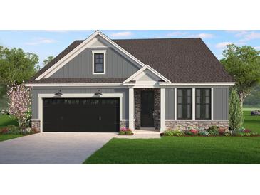Charming single-story home with gray siding, stone accents, black garage door, and well-maintained landscaping at 8605 Connor Ct, North Charleston, SC 29406