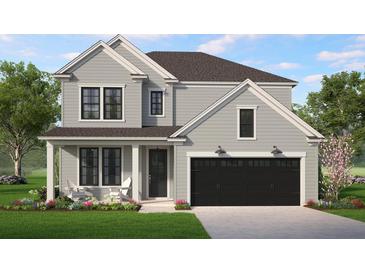 Charming two-story home features a black garage door, stylish black window frames, and a well-manicured lawn at 8629 Connor Ct, North Charleston, SC 29406