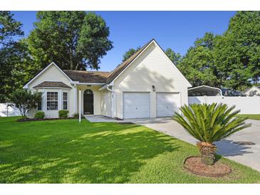 Charming single-Gathering home featuring an attached two-car garage, well-maintained lawn, and a mature palm tree at 103 Case Ct, Ladson, SC 29456