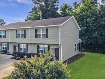 Two-story townhouse with light gray siding, landscaped front, and a well-maintained lawn at 1069 Lexi Ct, Ladson, SC 29456